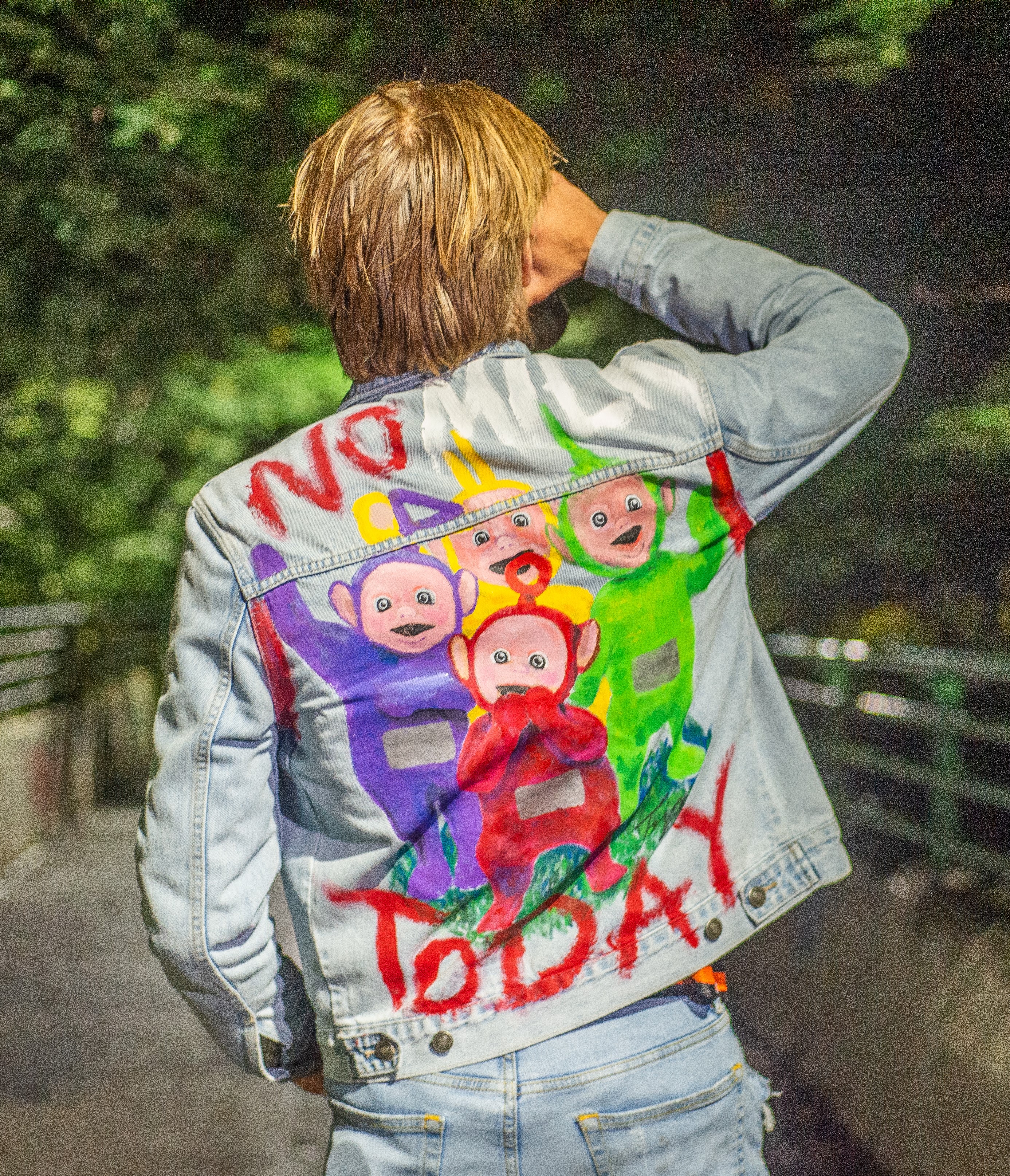 picture of a denim jecket with a painting of the teletubbies